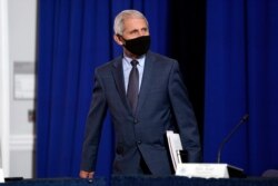 FILE - Dr. Anthony Fauci, director of the National Institute of Allergy and Infectious Diseases arrives to participate in a roundtable at the American Red Cross national headquarters in Washington.