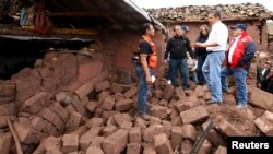 Peru's President Ollanta Humala (2nd R) visits a damaged area after a 5.1 magnitude earthquake hit Paruro, Cuzco, Sept. 28, 2014, in this Presidential handout photo.