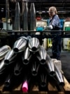 FILE - A steelworker moves an artillery projectile during the manufacturing process at the Scranton Army Ammunition Plant in Scranton, Pennsylvania, on April 13, 2023. The U.S. Defense Department said last week that some weapons deliveries to Ukraine will take months to complete.