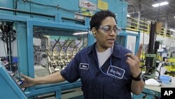 Gina Johnson performs leak tests on hydraulic fittings at the Eaton Corp. plant in Berea, Ohio, January 25, 2012.