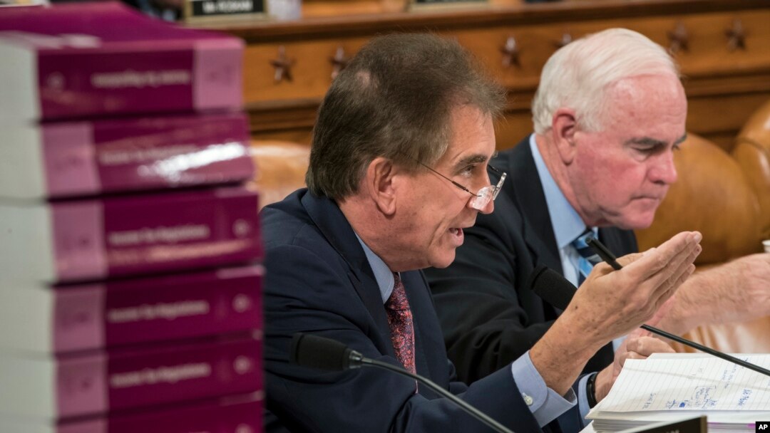 Rep. Jim Renacci, R-Ohio, joined at right by Rep. Pat Meehan, R-Pa., makes a point as the House Ways and Means Committee continues its debate over the Republican tax reform package, on Capitol Hill in Washington, Nov. 8, 2017.