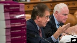 Rep. Jim Renacci, R-Ohio, joined at right by Rep. Pat Meehan, R-Pa., makes a point as the House Ways and Means Committee continues its debate over the Republican tax reform package, on Capitol Hill in Washington, Nov. 8, 2017.