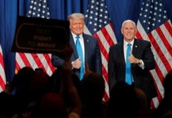 U.S. President Donald Trump and Vice President Mike Pence give thumbs up to the delegates after both addressing the first day of the 2020 Republican National Convention in Charlotte, North Carolina, Aug. 24, 2020.