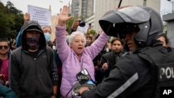 A woman shouts at police during a protest in front of the prosecutor's office following the disappearance in Guayaquil of four children who were last seen running away from a military convoy, in Quito, Ecuador, Dec. 23, 2024.