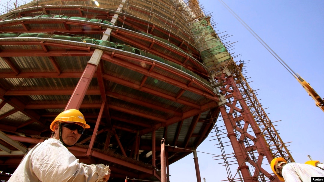 FILE - A building rises behind a Chinese engineer on the skyline of Khartoum, the capital of Sudan, in 2009. 
