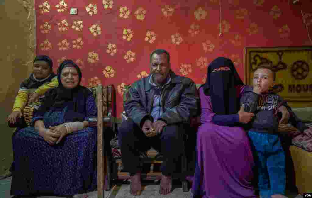 Abdallah lives with his wife (L), daughter (R), and grandsons. &quot;We share the same space with my other two siblings when they bring their families to visit and spend some days with us,&quot; he says. (Hamada Elrasam/VOA)