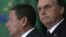 While Brazil's President Jair Bolsonaro was attending the World Economic Forum, Jan. 23, 2019, Vice President Hamilton Mourao, left, signed the decree expanding exceptions within the 2011 transparency law.