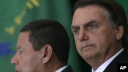 FILE - Brazil's President Jair Bolsonaro and his Vice President Hamilton Mourao attend a ceremony at Planalto presidential palace in Brasilia, Brazil, Jan. 7, 2019