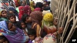 Pakistani villagers wait outside a hospital for blood screening for HIV at a hospital in a village near Ratodero, a small town in southern province of Sindh in Pakistan where the outbreak of deadly disease took place last month, Thursday, May 16, 2019. 