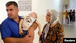 Iraqi Christians, who fled violence brought by Islamic State militants in the village of Qaraqosh, seek refuge inside a church building in Irbil, north of Baghdad, Aug. 11, 2014.