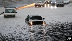 Vehicles are stranded by flood water in Auckland, Jan 28, 2023.