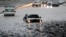 Vehicles are stranded by flood water in Auckland, Jan 28, 2023.