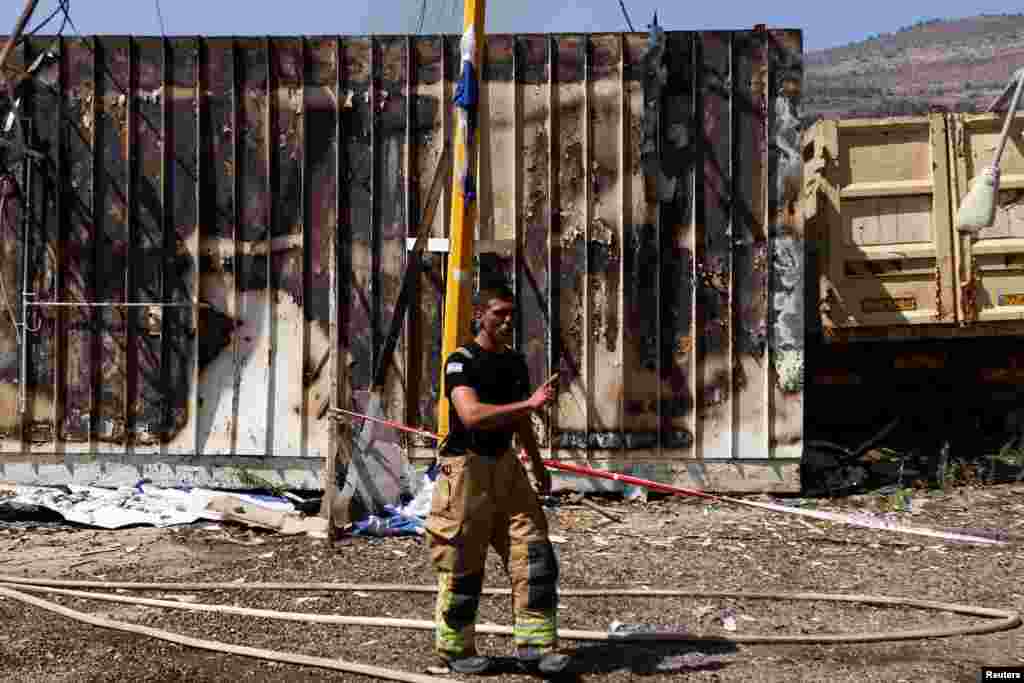 A firefighter stands at the site of a damaged city government building in Kiryat Shmona following a rocket attack from Lebanon, amid cross-border hostilities between Hezbollah and Israel, in northern Israel.