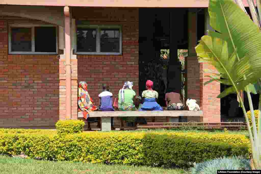 Relatives and prospective patients sit and wait for hours at the hospital.