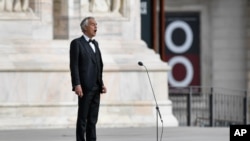 Italian singer Andrea Bocelli sings during a rehearsal outside the Duomo cathedral, on Easter Sunday, in Milan, April 12, 2020. 