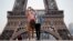 People take a selfie in front of the Eiffel Tower in 2020. A new French dictionary came out, supporting the way the language is spoken outside of France for the first time. (REUTERS/Gonzalo Fuentes)