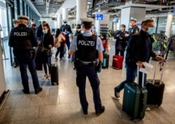 FILE - German police check arriving passengers for a negative coronavirus test in Frankfurt, March 30, 2021. The European Commission proposed April 29 issuing “Digital Green Certificates” to EU residents to facilitate travel in the bloc by summer.