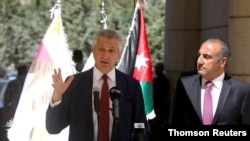 Amman Mayor Yousef Al-Shawarbeh listens to U.N. High Commissioner for Refugees Filippo Grandi as he speaks during the opening of a bazaar to mark World Refugee Day, in Amman, Jordan, June 20, 2019.