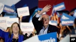 Democratic presidential candidate Sen. Bernie Sanders, I-Vt., right, with his wife Jane, speaks during a campaign event in San Antonio, Saturday, Feb. 22, 2020. (AP Photo/Eric Gay)