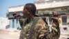 A Puntland police soldier stands guard outside police headquarters in Bossaso, Somalia, March 24, 2018. (J. Patinkin/VOA)