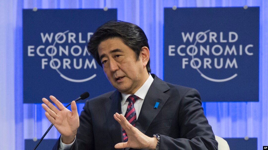Japanese Prime Minister Shinzo Abe gestures as he speaks at the World Economic Forum in Davos, Switzerland, Wednesday, Jan. 22, 2014.