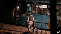 A Bosnian policeman secures an area where an armed man killed two soldiers, in Sarajevo, Bosnia and Herzegovina, Nov. 19, 2015.