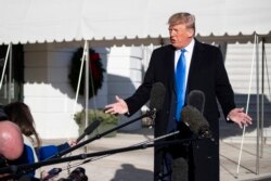 FILE - President Donald Trump speaks with reporters before boarding Marine One on the South Lawn of the White House, Dec. 7, 2019.
