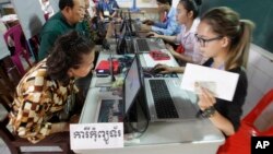 FILE PHOTO - Locals sit for registering their names during a voter registration process of the National Election Committee (NEC) in Phnom Penh, Cambodia, Thursday, Sept. 1, 2016. 