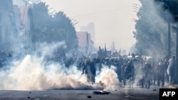 FILE - Police officers fire tear gas shells to disperse protesters in Islamabad on Nov. 26, 2024. Coverage of the protest led to one journalist being detained briefly and another called in for questioning amid a surge of media suppression and violence in Pakistan this year.