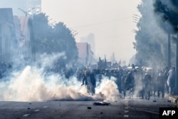 Police personnel fire tear gas shells to disperse supporters of the Pakistan Tehreek-e-Insaf party during a protest demanding the release of former Prime Minister Imran Khan in Islamabad on Nov. 26, 2024.