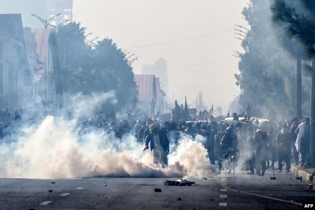 Police personnel fire tear gas shells to disperse supporters of the Pakistan Tehreek-e-Insaf party during a protest demanding the release of former Prime Minister Imran Khan in Islamabad on Nov. 26, 2024.