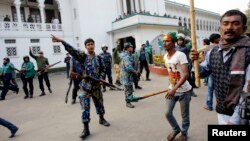 Police try to stop activists of ruling party Bangladesh Awami League from attacking lawyers loyal to Bangladesh Nationalist Party (BNP) and Bangladesh Jamaat-E-Islami during a protest inside the premises of Supreme Court in Dhaka, Dec. 29, 2013.