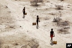 خشکسالی در شرق آفریقا - پسر بچه‌های کنیایی مسافت دوری را برای حمل آب از چاه یک روستا طی می‌کنند. (آرشیو)