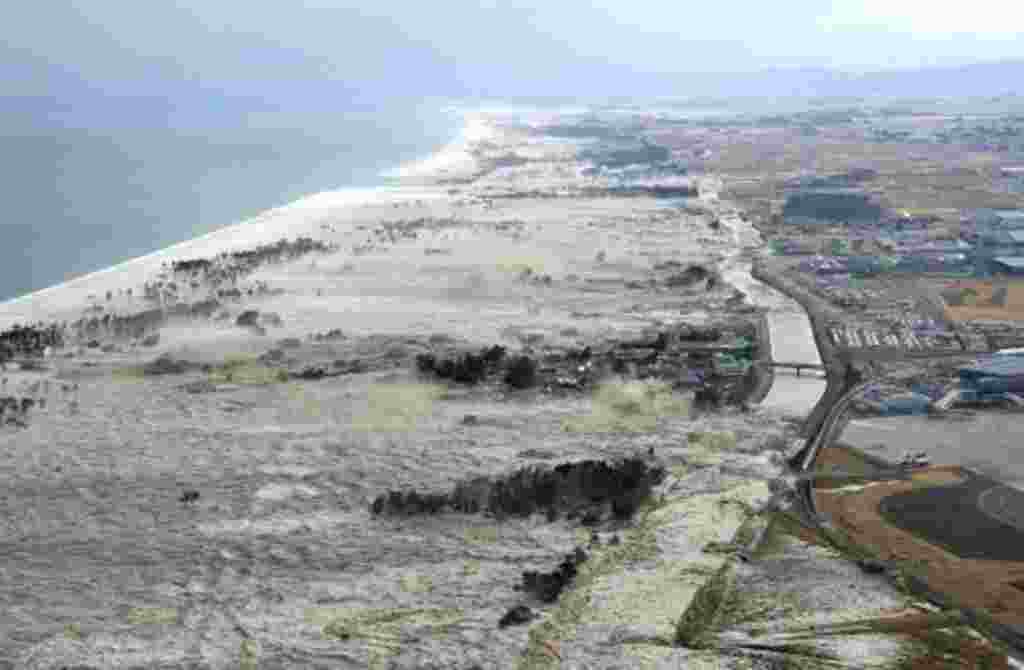 A massive tsunami hits the coastal areas of Iwanuma, Miyagi Prefecture, northeastern Japan, march 11, 2011