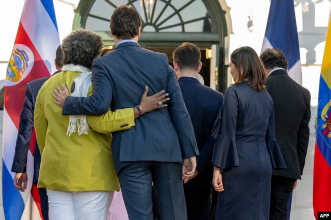 Canadian Prime Minister Justin Trudeau, center, embraces Barbados Prime Minister Mia Mottley at the White House in Washington on Nov. 3, 2023, during the inaugural Americas Partnership for Economic Prosperity Leaders’ Summit.