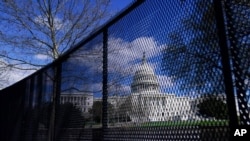 FILE - The U.S. Capitol is seen behind security fencing in Washington, April 2, 2021. It was later removed, but law enforcement concerned about the prospect of violence at a D.C. rally in September plan to reinstall it, a source said.