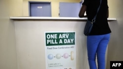 FILE - A woman queues at Phedisong clinic on April 8, 2013, during the launch of the new single dose anti-AIDS drug in Ga-Rankuwa, north of Johannesburg. South Africa is considered a success story for its treatment for and prevention of HIV. 