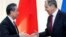 FILE - Russian Foreign Minister Sergey Lavrov shakes hands with Chinese Foreign Minister Wang Yi after their joint news conference following talks in Sochi, Russia, May 13, 2019. 