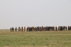 As IS lost holdings across Iraq and Syria between 2016 and 2018, women and men would be separated as authorities searched for militants, pictured near Baghouz, Syria, Feb. 27, 2019. (H.Murdock/VOA)