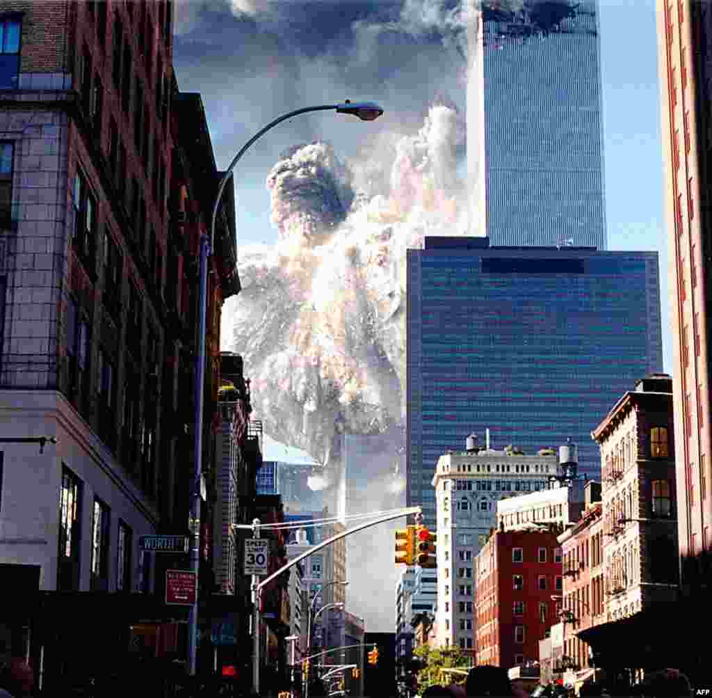 (FILE)&nbsp;The south tower of the World Trade Center collapses sending dust and smoke into the streets 11 September, 2001, in New York. Two planes crashed into the towers which later collapsed. AFP PHOTO/Aaron MILESTONE (Photo by AARON MILESTONE / AFP)