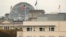FILE - The American flag flies on top of the U.S. Embassy in front of the Reichstag building that houses the German parliament in Berlin.