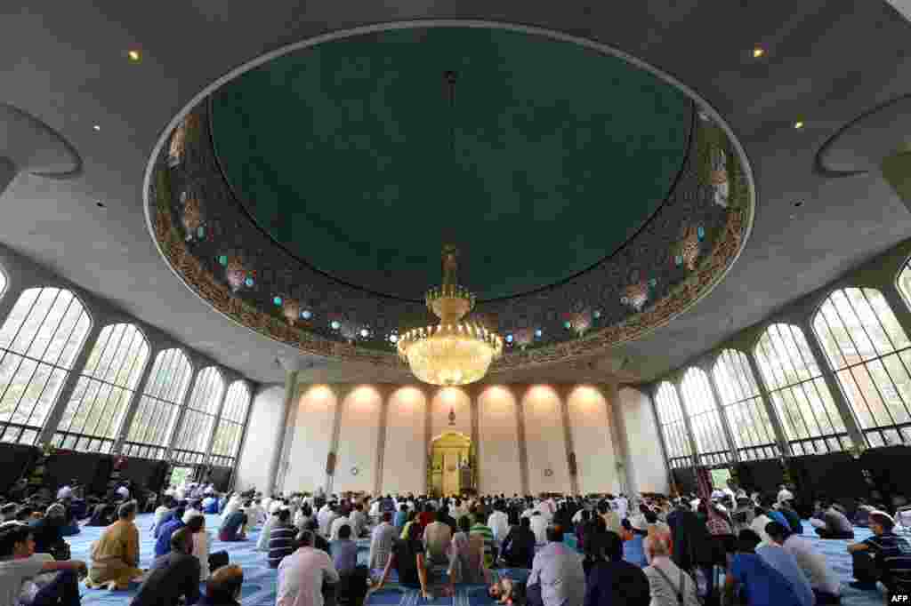 Muslim men attend prayers on Eid Al-Fitr day at the Regent's Park Mosque in London on August 19, 2012.