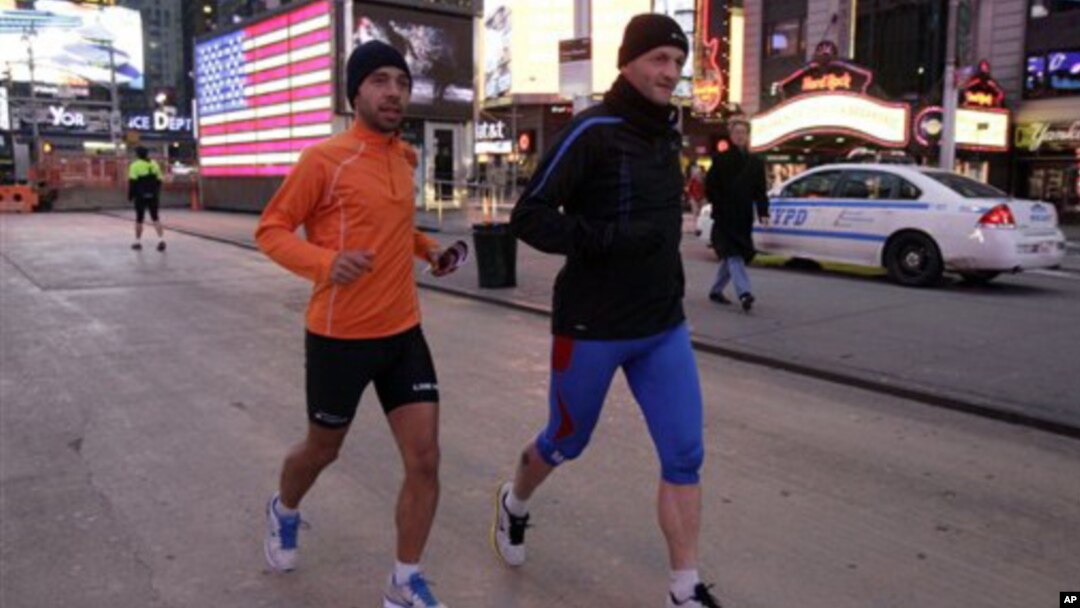 Ricardo Burnia (kiri) dan Simon Capaccioni dari Italia tengah melatih diri untuk persiapan mengikuti lomba marathon di Times Square, New York (2/11). Lomba marathon tahunan yang semula direncanakan akan digelar hari Minggu, dibatalkan oleh walikota Bloomberg, setelah mendapat tekanan warga korban badai Sandy, yang memprotes keputusan walikota sebelumnya untuk terus menggelar acara ini.