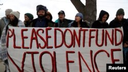 FILE - Opponents of the Dakota Access oil pipeline rally outside the Bank of North Dakota in Bismarck, Jan. 31, 2017.