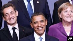 President Barack Obama, flanked by French President Nicolas Sarkozy, left, and German Chancellor Angela Merkel, are seen during the NATO Official group photo of the North Atlantic Council summit in Lisbon , Portugal.