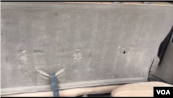A bullet hole in the back seat of Deputy Printemps Belizaire’s Toyota SUV.