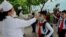 FILE - Kim Song Ju Primary School students have their temperatures checked in Pyongyang, North Korea, June 3, 2020. After months of denying it had any coronavirus infections, North Korea reported its first suspected case July 25, 2020.