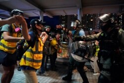 People block policemen who arrive to arrest protesters at Tung Chung near airport in Hong Kong, Sunday, Sept.1, 2019.