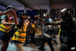 People block policemen who arrive to arrest protesters at Tung Chung near airport in Hong Kong, Sunday, Sept.1, 2019.