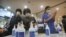 Women wearing face masks to help protect against the coronavirus use hand sanitizer before attending a service at the Yoido Full Gospel Church in Seoul, South Korea, July 5, 2020. 